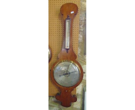 A 19th century oak cased wheel barometer, with large silvered dials and shaped outline