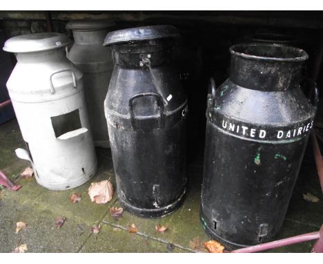 Four vintage cast iron two handled milk churns with later painted finish and raised lettering to band, United Dairies, Co-op 