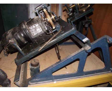 A substantial cast iron framed turret/industrial clock movement, with brass cogs and electric motor, manufactured by John Smi