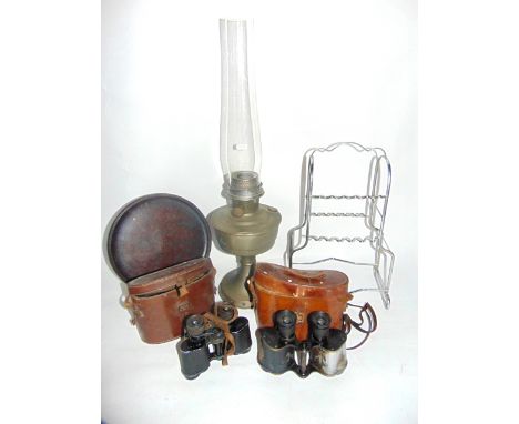 A stainless steel two tiered pipe rack together with an oil burner lamp with clear glass chimney and metallic reservoir, leat