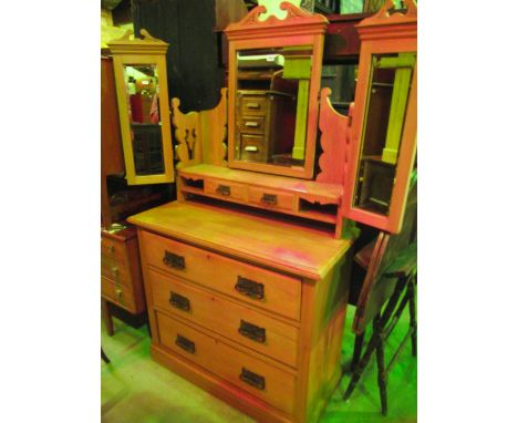 An Edwardian satin walnut dressing chest with triple mirror back and two central trinket drawers over three long drawers to b