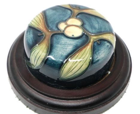 Moorcroft paperweight in the Olive tree pattern on a wooden base, D: 90 mm. P&amp;P Group 1 (£14+VAT for the first lot and £1