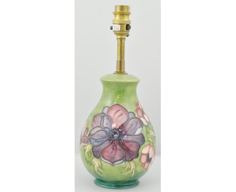 Moorcroft table lamp, with floral decoration to a green ground, approximately 20cm.
