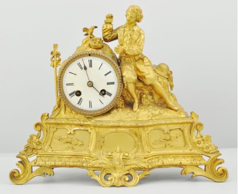 19th Century gilt spelt mantel clock, the case mounted with a figure, circular enamel dial with Roman numerals, movement mark