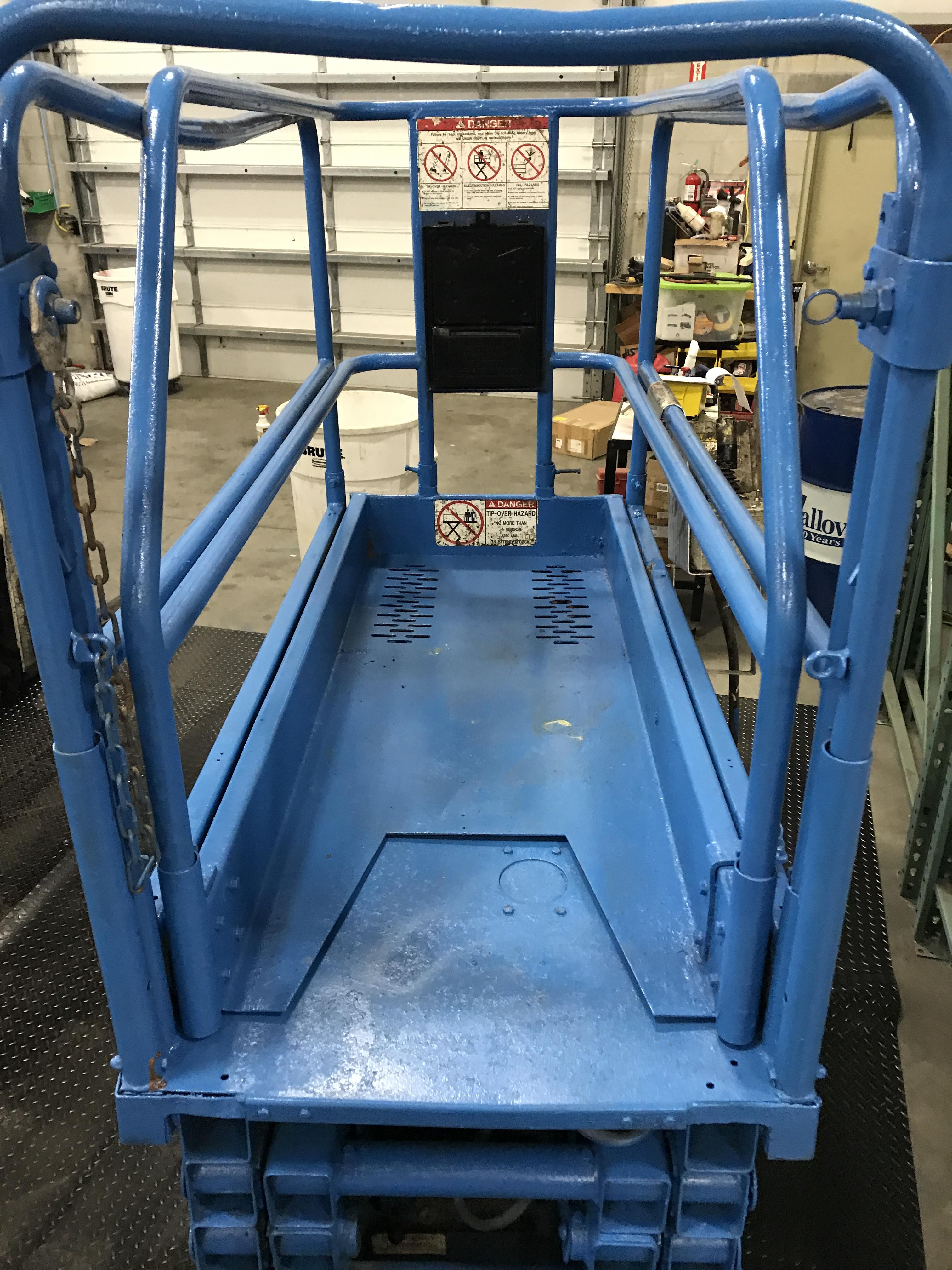 MX19 UPRIGHT SCISSOR LIFT W/ BUILT IN BATTERY CHARGER, RUNS AND