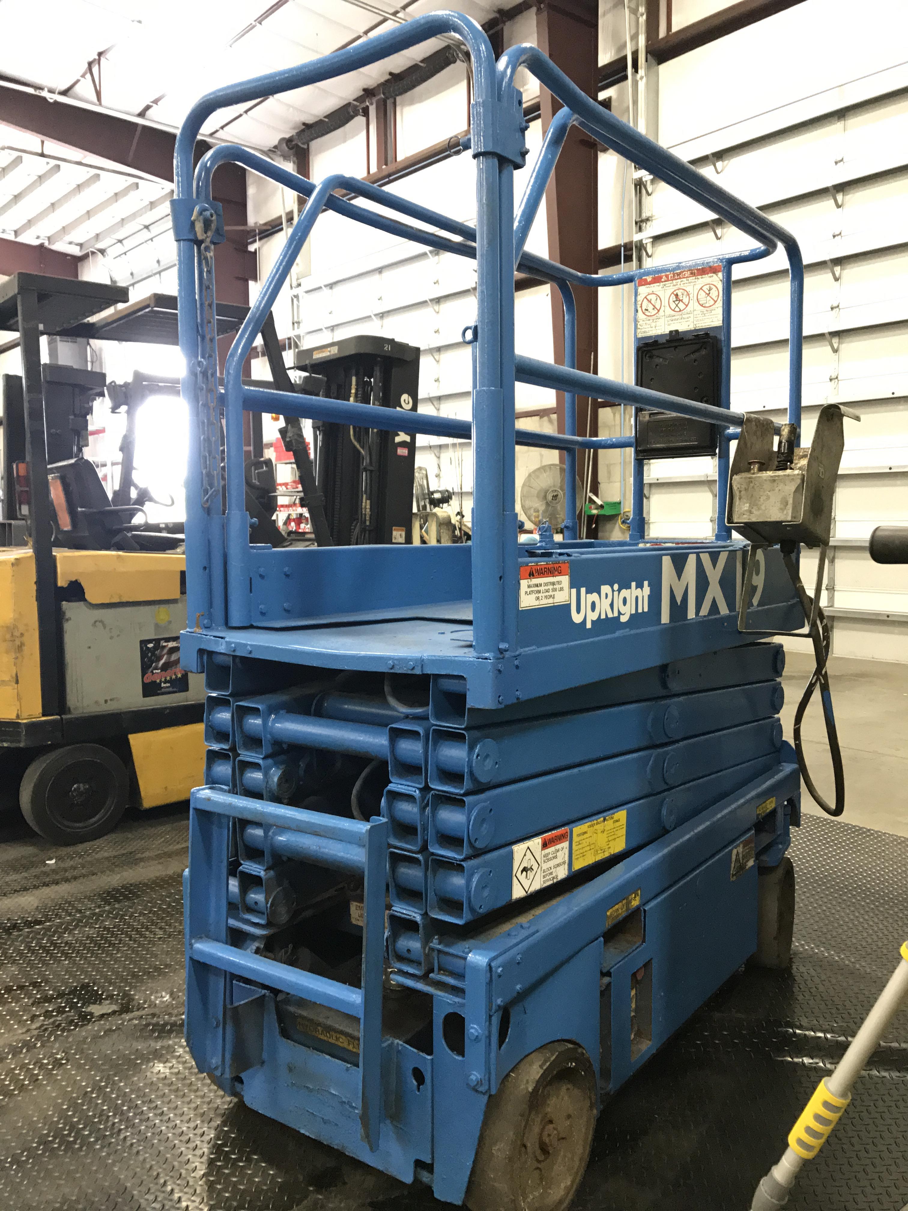 MX19 UPRIGHT SCISSOR LIFT W/ BUILT IN BATTERY CHARGER, RUNS AND