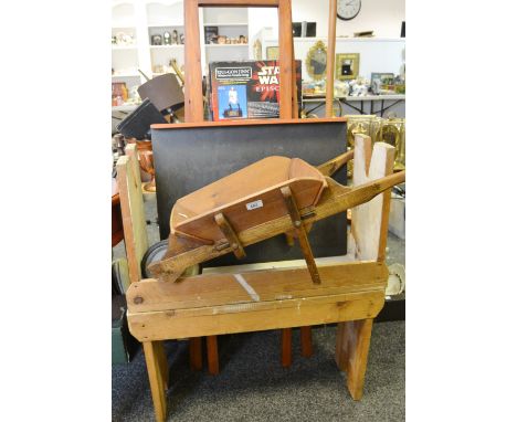 An early/mid 20th century scratch built oak and pine wheelbarrow; a mahogany artists easel; a pair of pine work stools (4)