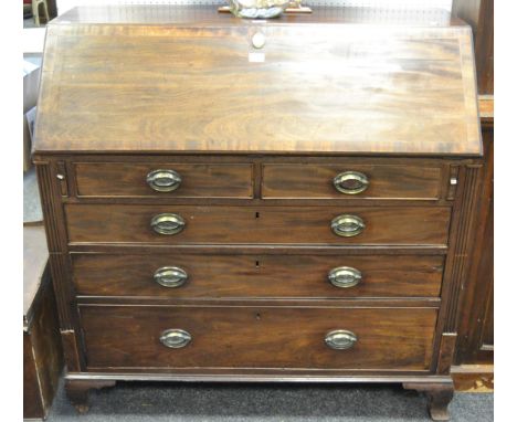 A George III bureau, fall front enclosing drawers and pigeon holes, two short cock beaded drawers above three long, bracket f