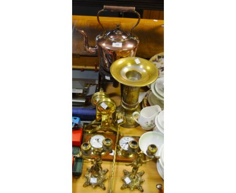 A copper kettle; a pair of brass fire dogs; a hardwood three legged stool; a pair of brass figural candlesticks; toasting for