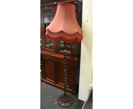 An early 20th Century oak standard lamp