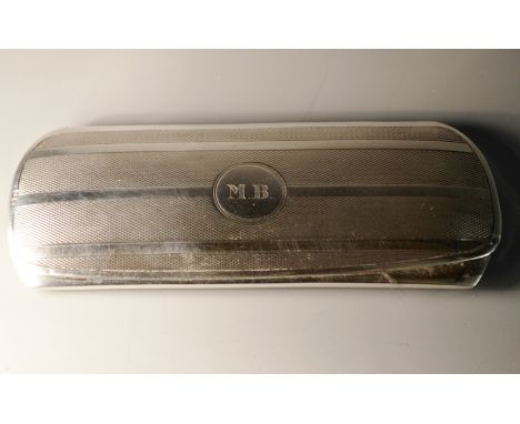 A George V silver rounded rectangular spectacles case, engine turned, blue velvet lining, the central circular cartouche with