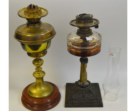 A Victorian cast iron and brass oil lamp, circa. 1870; another (2)