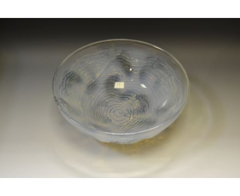 A Lalique glass Dauphin pattern bowl, Fish swimming among spiral waves, etched R. Lalique, 24cm diameter (faults)