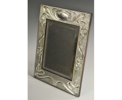 An Art Nouveau silver rectangular easel dressing table mirror, embossed with flag irises and sinuous scrolls, vacant oval car