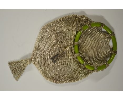 An unusual Art Deco silver colured metal mesh evening purse, the pennant shaped bag suspended from a bangle handle of simulat