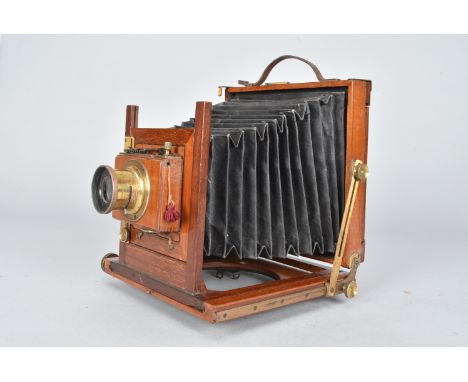 A half-plate Folding Field Camera, F/8 lens, Thornton-Pickard roller blind shutter and tripod turntable in base 