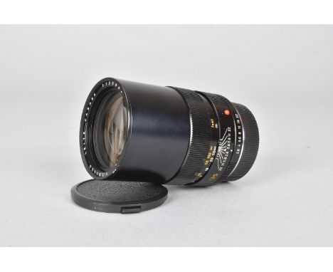 A Leitz Canada Elmarit-R 135mm f/2.8 Lens, serial no 3135853, 1981, triple-cam, barrel G, elements G, dust, with front and re