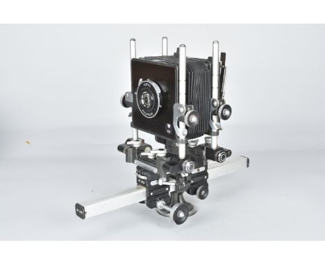 A De Vere 5 x 4in Monorail View Camera, body G, with a Tominon 127mm f/4.7 lens, VG, Copal Polaroid shutter working with a 9 