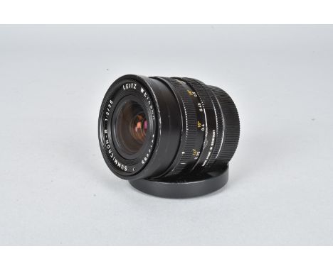 A Leitz Wetzlar Summicron-R 35mm f/2 Lens, serial no 2819585, 1977, triple-cam, barrel F, chips and marks, elements VG, with 