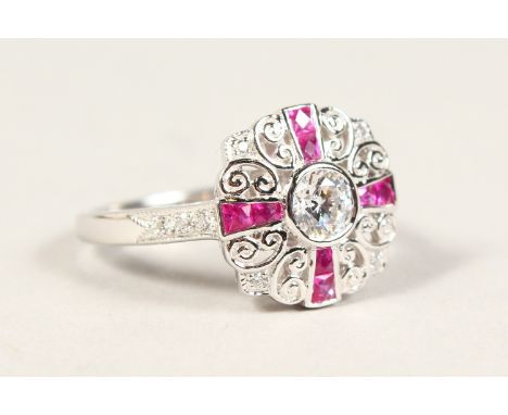 A SILVER, ZIRCON AND RUBY RING.