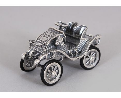 A NOVELTY SILVER MINIATURE VINTAGE CAR.