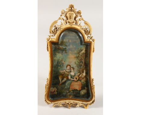 A LATE 18TH CENTURY FRENCH CARVED IVORY FRAMED EASEL PICTURE, the frame with crest and pierced decoration, the painted panel 