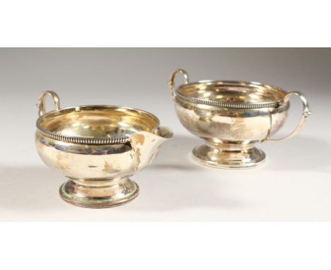 A CIRCULAR TWO-HANDLED SUGAR BASIN AND MILK JUG, with bead edge. Birmingham 1935.  Weight 6ozs.