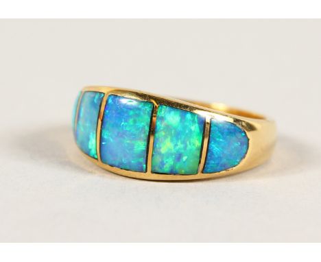 AN 18CT GOLD AND BLUE OPAL RING.