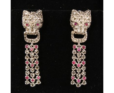 A PAIR OF SILVER MARCASITE RUBY SET PANTHER EARRINGS.