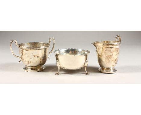 A CIRCULAR SUGAR BASIN AND MILK JUG, Birmingham 1929, and A CIRCULAR BOWL inset with a coin (3).