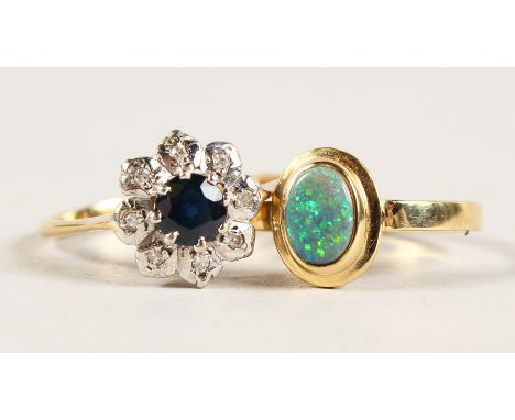 A 9CT GOLD OPAL RING and A CLUSTER RING.