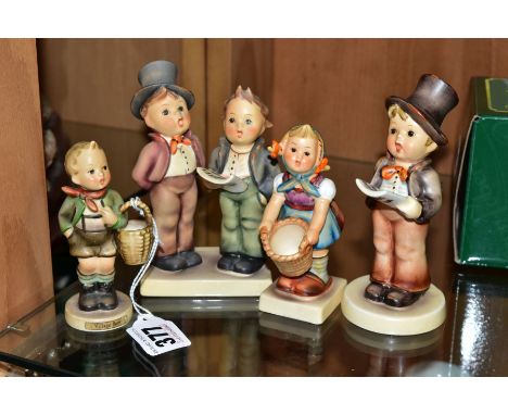 FOUR HUMMEL FIGURES AND TWO DISPLAY STANDS, 'Village Boy' HUM51, 'Little Helper' HUM73, 'Duet' HUM130 and 'Street Singer' HUM