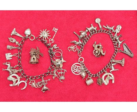 TWO WHITE METAL CHARM BRACELETS AND TWO CHARMS, the first bracelet suspending seventeen charms in forms such as animals, teap