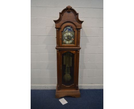 A GOLDEN OAK CHIMING LONGCASE CLOCK, arched glass door enclosing a brassed dial, with automaton movement, roman numerals, sec