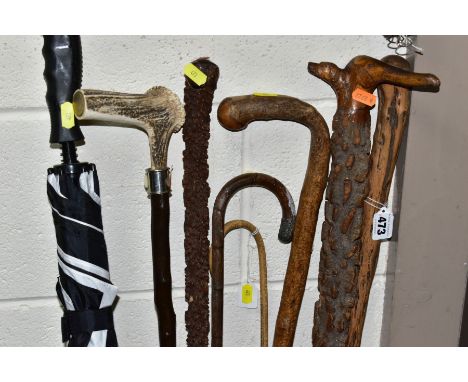 A BUNDLE OF SIX LATE VICTORIAN/20TH CENTURY WALKING STICKS/CANES, an umbrella and a teacher's cane, including a walking stick