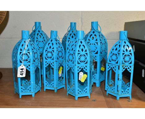 A SET OF SEVEN TURQUOISE PAINTED TEA LIGHT HOLDERS, of Middle Eastern lantern style, three height 24cm and four height 20.5cm