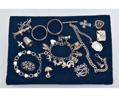 A SELECTION OF SILVER AND WHITE METAL ITEMS, to include a silver charm bracelet suspending thirteen white metal charms in for