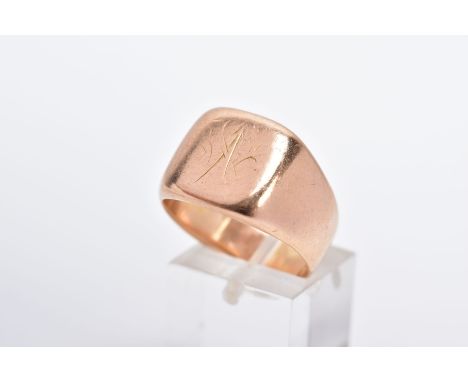 A YELLOW METAL SIGNET RING, worn engraving to the front panel, approximately 14mm x 14mm in size, stamped 750 (tested as 18ct