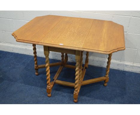 A GOLDEN OAK BARLEY TWIST GATE LEG TABLE