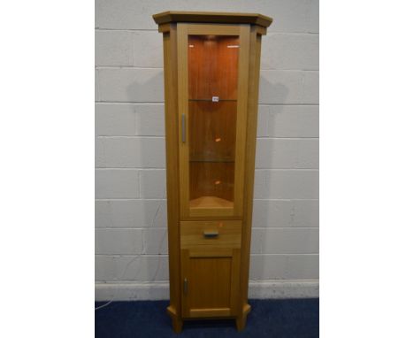 A MORRIS FURNITURE COMPANY, RANGE HORIZON, LIGHT OAK GLAZED SINGLE DOOR CORNER CUPBOARD, above a single cupboard door/dummy d