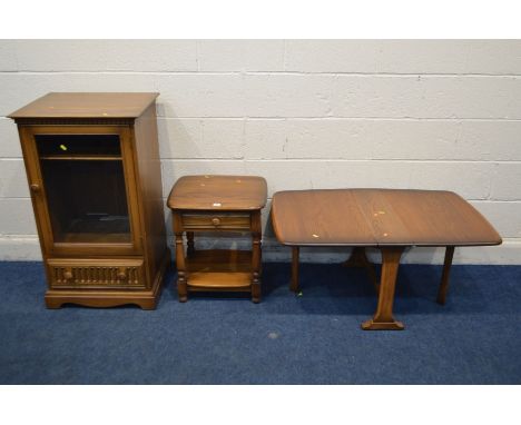 AN ERCOL GOLDEN DAWN ASH LAMP TABLE with a single drawer, along with a matching drop leaf occasional table and a glazed singl