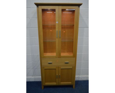 A MORRIS FURNITURE COMPANY, RANGE HORIZON, LIGHT OAK GLAZED TWO DOOR BOOKCASE, two glass shelves, internal lighting, with two