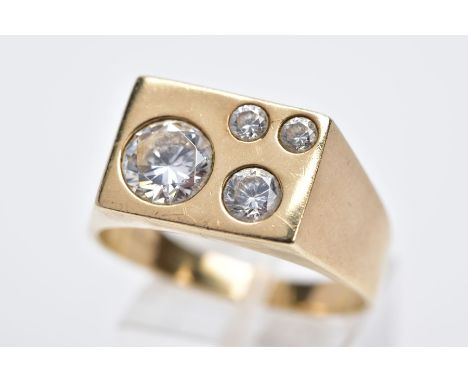 A 9CT GOLD, CUBIC ZIRCONIA SET SIGNET RING, of a rectangular form set with four graduated circular cut colourless cubic zirco