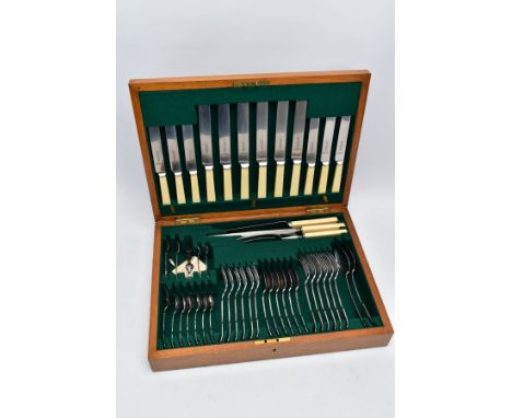 A COMPLETE CANTEEN OF CUTLERY, a light wooden canteen containing a forty eight piece set includes plastic handled 'E.M.Dickin