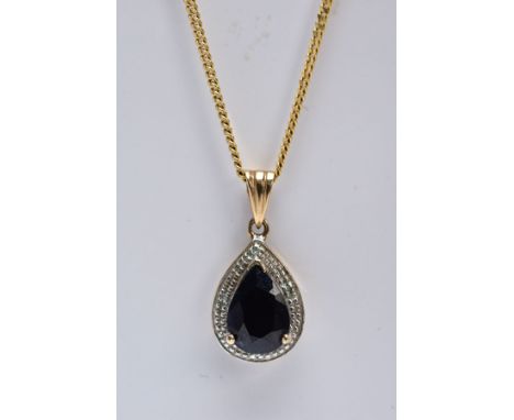 A 9CT GOLD SAPPHIRE AND DIAMOND PENDANT NECKLET, the pendant of a tear-drop shape, set with a pear cut blue sapphire, within 