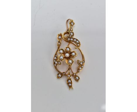 A YELLOW METAL SEED PEARL PENDANT, of an openwork design, featuring a central flower set with a seed pearl and split pearl de