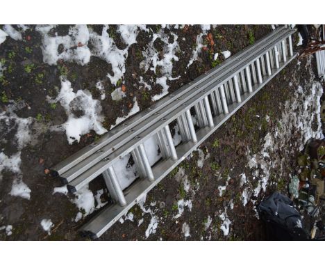 AN ALUMINIUM TRIPLE EXTENSION LADDER with 13 rungs to each 3.4m section