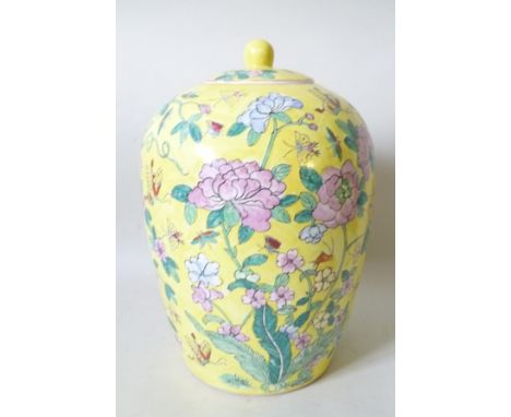 A CHINESE CERAMIC GINGER JAR AND COVER hand painted with blossom decoration on a yellow ground, 34cm high 