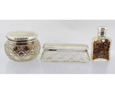 TWO CUT GLASS DRESSING TABLE JARS with silver covers, together with a plain SCENT BOTTLE with silver screw cap, 7cm high 