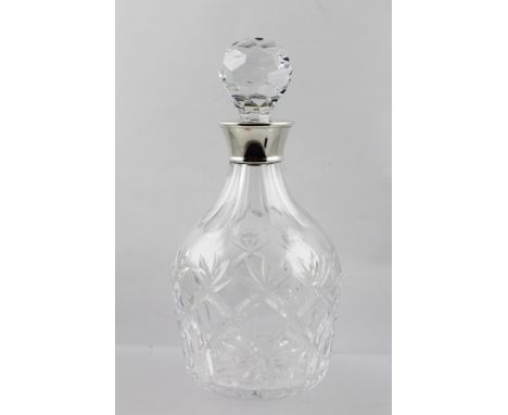 E**S**C** AN ENGLISH CUT LEAD CRYSTAL PORT WINE DECANTER with applied spun silver collar, Birmingham 1976, 24cm high 